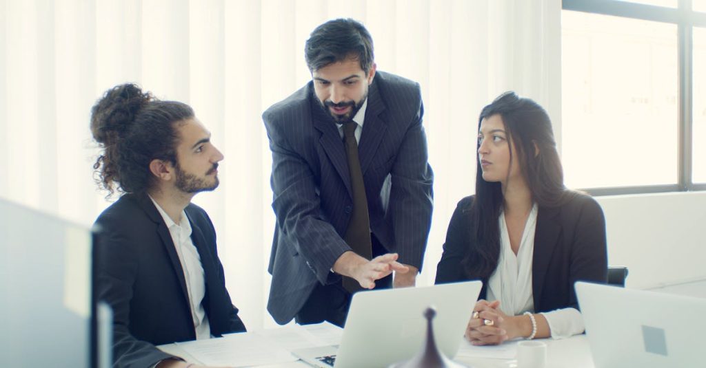 Professional team in office discussing a business project with focused collaboration.